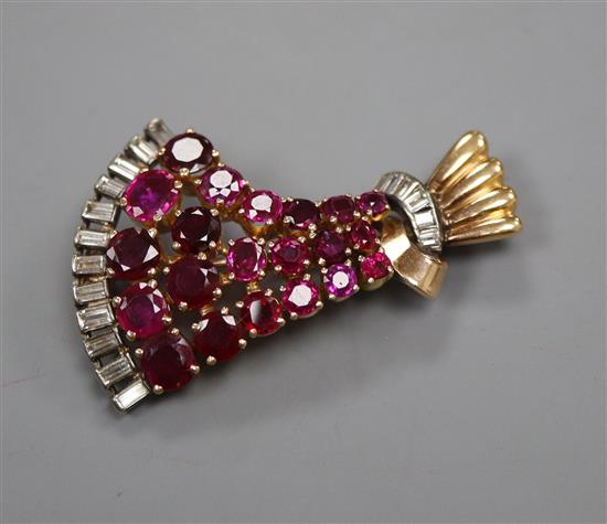 A 1950s yellow metal,ruby and diamond set fan shaped brooch, 44cm.